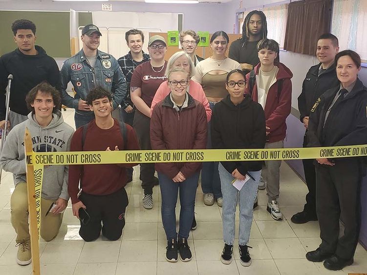 A group of people standing with crime scene tape