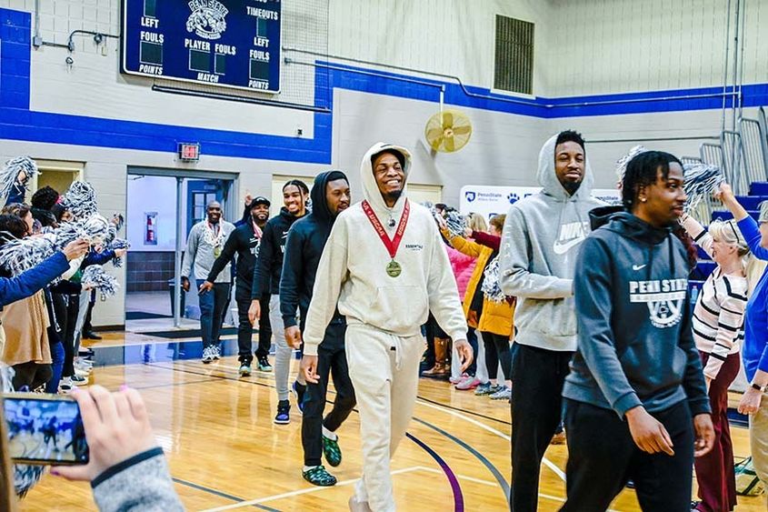 Team members walking into the gymnasium