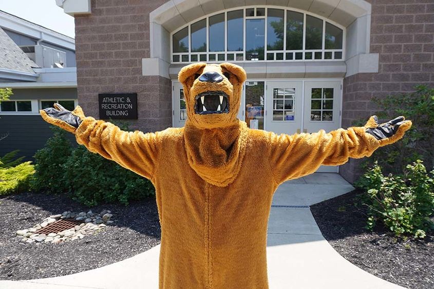 The Nittany Lion standing with open arms.