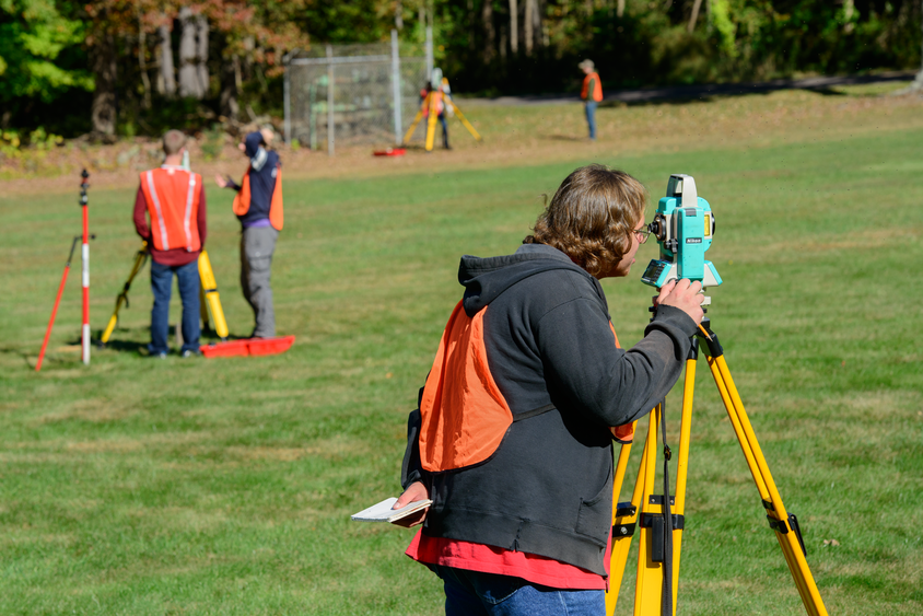 Students using surveying equipment