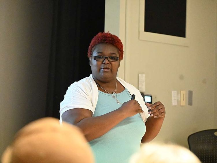 Woman standing near podium and speaking