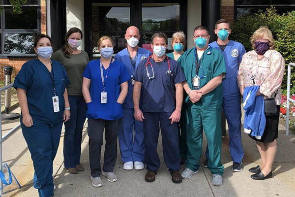 Healthcare professionals standing outside nursing home