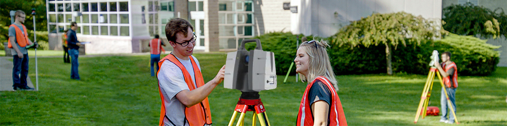 Surveying students working hands-on with equipment outside of the Center for Technology